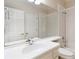 Bright bathroom features a large mirror, white cabinets, and a shower-tub combo at 2280 Wildwood Lake Dr, Suwanee, GA 30024