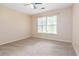 Neutral bedroom with carpet, a ceiling fan, and a large window at 2280 Wildwood Lake Dr, Suwanee, GA 30024