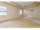 Spacious bedroom boasts tray ceilings, neutral walls, and plush carpeting at 2280 Wildwood Lake Dr, Suwanee, GA 30024