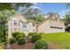 Elegant two-story home showcasing lush front lawn, attached two car garage, and well-maintained landscaping at 2280 Wildwood Lake Dr, Suwanee, GA 30024