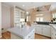 Open kitchen features light-colored cabinets and a kitchen island at 2280 Wildwood Lake Dr, Suwanee, GA 30024