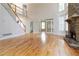 Open living space with fireplace, hardwood floors, staircase and transom window french doors at 2280 Wildwood Lake Dr, Suwanee, GA 30024