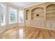 Cozy room featuring hardwood floors, built-in shelving, bay windows, and soft natural light, perfect for relaxation at 2280 Wildwood Lake Dr, Suwanee, GA 30024