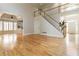 Spacious living area with hardwood flooring, staircase, and abundant natural light streaming through large windows at 2280 Wildwood Lake Dr, Suwanee, GA 30024