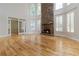 Spacious living room with a stone fireplace and large windows at 2280 Wildwood Lake Dr, Suwanee, GA 30024