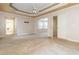 Bright main bedroom features a tray ceiling, neutral walls, and multiple windows at 2280 Wildwood Lake Dr, Suwanee, GA 30024