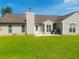 Backyard featuring a grass lawn, patio, and neutral-colored home exterior at 35 Creek Bend Trl, Oxford, GA 30054