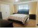 Comfortable bedroom features a king bed, carpet, neutral colors, and a large window at 35 Creek Bend Trl, Oxford, GA 30054