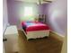 Stylish bedroom with lavender walls, plush carpet, and a white bed frame at 35 Creek Bend Trl, Oxford, GA 30054