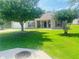 Inviting single-story home featuring lush green lawn, mature trees, and a cozy front porch at 35 Creek Bend Trl, Oxford, GA 30054