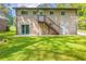 Exterior of the home featuring a staircase and a grassy yard at 4345 Kimball Sw Rd, Atlanta, GA 30331