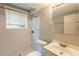 Bathroom featuring a shower, toilet, sink, and a window at 4345 Kimball Sw Rd, Atlanta, GA 30331