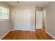 Bedroom featuring hardwood floors, neutral walls, closet, and natural light from window at 4345 Kimball Sw Rd, Atlanta, GA 30331
