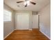 Bedroom boasts hardwood floors, a ceiling fan, closet, and two entry doors at 4345 Kimball Sw Rd, Atlanta, GA 30331