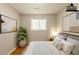 A staged bedroom featuring a bed, side table, lamp, artwork and plant at 4345 Kimball Sw Rd, Atlanta, GA 30331