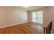 Bright bedroom featuring hardwood floors, neutral walls, and a large window at 4345 Kimball Sw Rd, Atlanta, GA 30331
