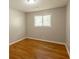 Bedroom featuring hardwood floors, neutral walls, ceiling fan and natural light from a window at 4345 Kimball Sw Rd, Atlanta, GA 30331