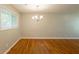 Bright dining room featuring gleaming hardwood floors, a modern chandelier, and a large window at 4345 Kimball Sw Rd, Atlanta, GA 30331