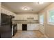 Functional kitchen featuring white cabinets, granite countertops, black appliances, and easy access to back door at 4345 Kimball Sw Rd, Atlanta, GA 30331