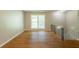 Spacious living area with hardwood floors, large window, staircase with iron railing, and neutral wall color at 4345 Kimball Sw Rd, Atlanta, GA 30331