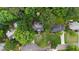 An aerial view of a home nestled among mature trees, showcasing its spacious lot and neighborhood location at 4648 Equestrian Way, Atlanta, GA 30338