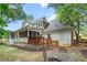 Beautiful backyard with a deck, screened-in porch, lush lawn, and a patio set for relaxing outdoors at 4648 Equestrian Way, Atlanta, GA 30338