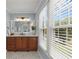 Bright bathroom featuring a wood vanity, white marble countertop, and ample natural light at 4648 Equestrian Way, Atlanta, GA 30338