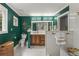 Green bathroom with a glass shower and a basket near the toilet at 4648 Equestrian Way, Atlanta, GA 30338