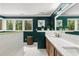 Luxurious bathroom featuring a double vanity, marble countertops, and elegant green wall paint at 4648 Equestrian Way, Atlanta, GA 30338