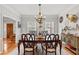 Elegant dining room with modern chandelier, hardwood floors, and wainscoting at 4648 Equestrian Way, Atlanta, GA 30338