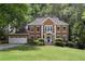 Beautiful two-story brick home with a well-manicured lawn and a two-car garage at 4648 Equestrian Way, Atlanta, GA 30338