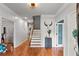 Inviting foyer with hardwood floors, staircase, and modern light fixtures at 4648 Equestrian Way, Atlanta, GA 30338