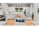 Bright, updated kitchen featuring white cabinets, marble countertops, hardwood floors, and stainless steel appliances at 4648 Equestrian Way, Atlanta, GA 30338
