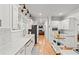 Well-lit modern kitchen with white cabinets, marble countertops, wooden floors, and an island at 4648 Equestrian Way, Atlanta, GA 30338