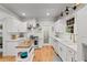 Bright kitchen featuring stainless steel appliances, white cabinets, marble countertops, wooden floors, and a kitchen island at 4648 Equestrian Way, Atlanta, GA 30338