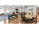 Open-concept living space with hardwood floors, fireplace, dining, and play area at 4648 Equestrian Way, Atlanta, GA 30338