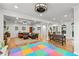 Open-concept living space featuring hardwood floors, fireplace, dining, and play area at 4648 Equestrian Way, Atlanta, GA 30338