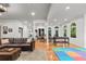 Open-concept living space featuring hardwood floors, fireplace, dining, and play area at 4648 Equestrian Way, Atlanta, GA 30338