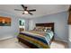 Primary bedroom suite featuring blue walls, carpet flooring, ensuite bath, ceiling fan, and a window at 4648 Equestrian Way, Atlanta, GA 30338