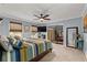 Large bedroom with blue walls, ceiling fan, carpet, two windows and attached dressing area at 4648 Equestrian Way, Atlanta, GA 30338