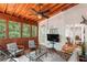 This is a bright sunroom featuring white walls, tongue-and-groove ceiling, and a comfortable seating area at 4648 Equestrian Way, Atlanta, GA 30338