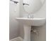 Elegant bathroom featuring a pedestal sink and stylish fixtures at 4695 Ravenwood Loop, Union City, GA 30291