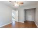 Bedroom with wood-look flooring, ceiling fan and entry into hallway at 4695 Ravenwood Loop, Union City, GA 30291