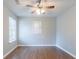 Bedroom featuring a ceiling fan, wood flooring, and a large window for natural light at 4695 Ravenwood Loop, Union City, GA 30291