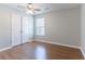 Bedroom with modern fan, wood floors and a large window; featuring a double closet at 4695 Ravenwood Loop, Union City, GA 30291