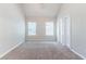 Spacious bedroom with neutral carpet, two windows, and a high vaulted ceiling at 4695 Ravenwood Loop, Union City, GA 30291