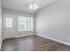 Bright dining area featuring hardwood floors, a window, and a modern light fixture at 4695 Ravenwood Loop, Union City, GA 30291
