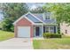 Charming home featuring a brick facade, manicured lawn, garage, and inviting entrance at 4695 Ravenwood Loop, Union City, GA 30291
