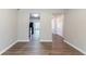 Hallway with hardwood floors and connecting spaces to the kitchen at 4695 Ravenwood Loop, Union City, GA 30291