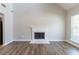 Open living room featuring hardwood floors, fireplace, and abundant natural light at 4695 Ravenwood Loop, Union City, GA 30291